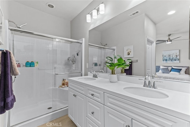 bathroom with vanity, an enclosed shower, and ceiling fan