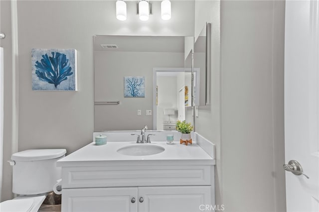 bathroom with vanity and toilet