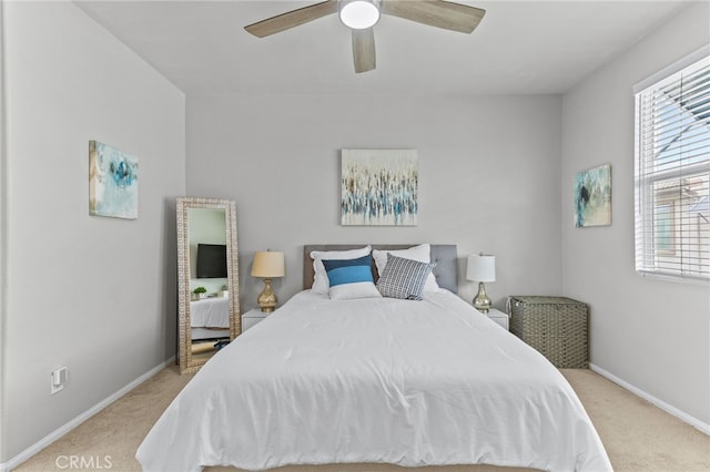 bedroom with light carpet and ceiling fan