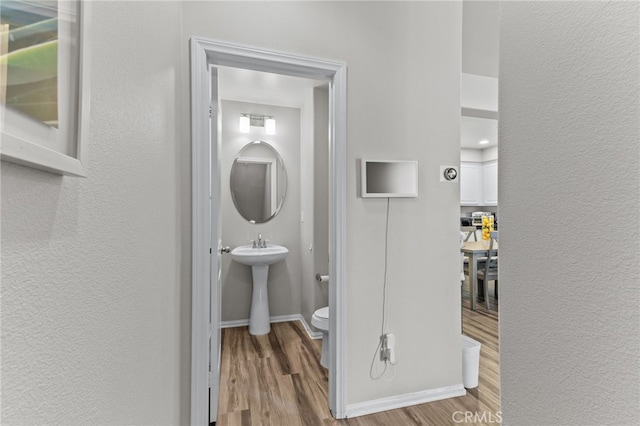 bathroom featuring hardwood / wood-style flooring, sink, and toilet