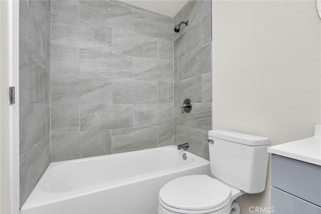 full bathroom featuring vanity, tiled shower / bath combo, and toilet