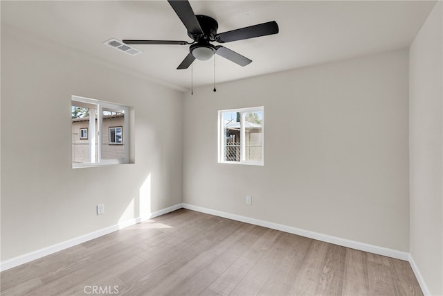 empty room featuring ceiling fan and light hardwood / wood-style floors