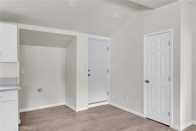 interior space featuring vaulted ceiling and light wood-type flooring