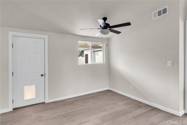 spare room with light hardwood / wood-style floors and ceiling fan