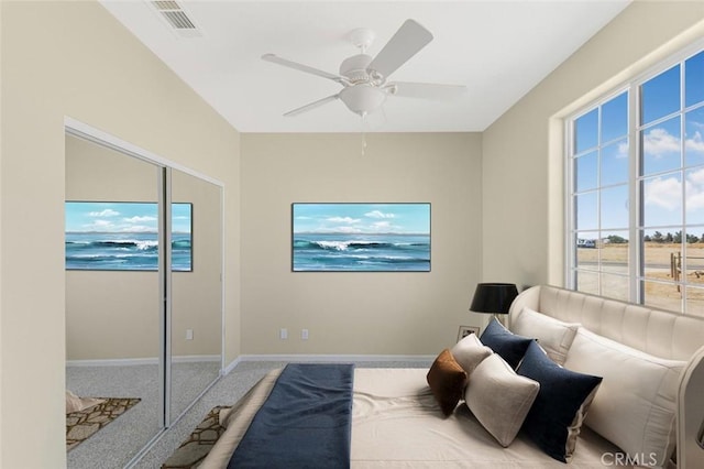 bedroom with ceiling fan, carpet flooring, and a closet