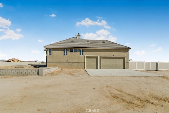 rear view of house featuring a garage