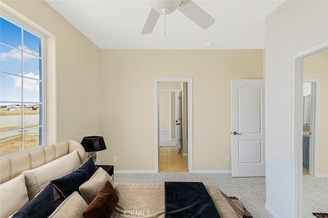 carpeted bedroom with multiple windows and ceiling fan