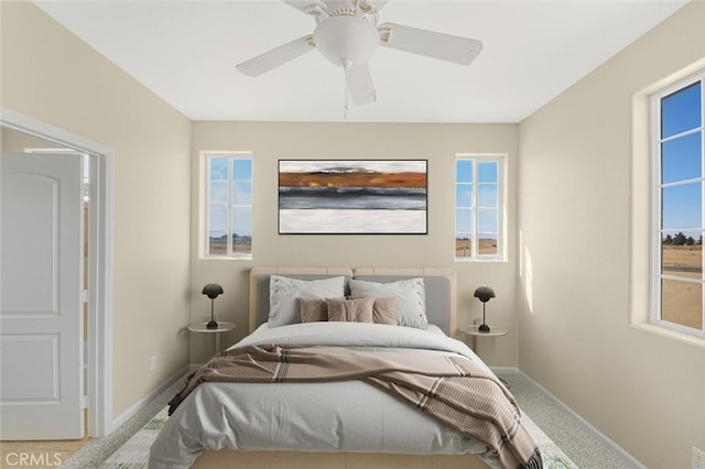 bedroom with multiple windows, carpet floors, and ceiling fan