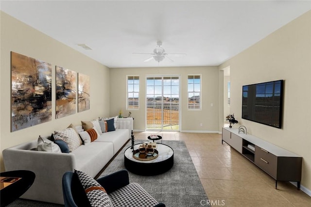 living room with ceiling fan and light tile patterned flooring