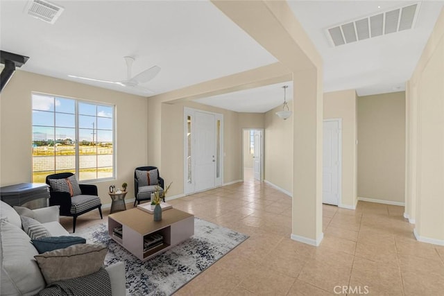 living room featuring ceiling fan and light tile patterned flooring