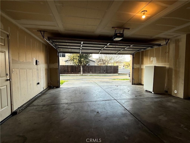 garage with a garage door opener and refrigerator