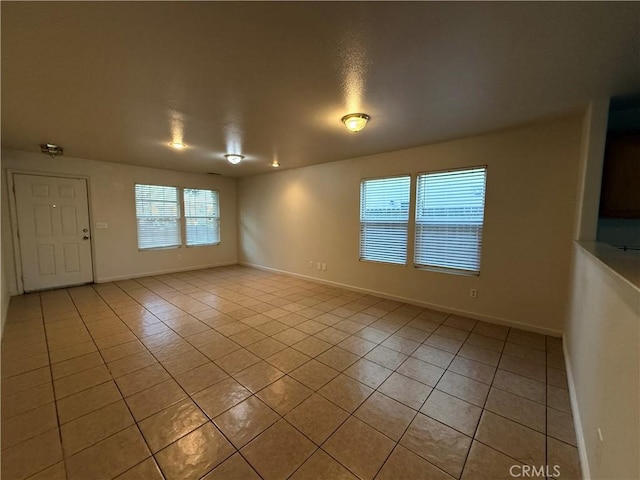 spare room featuring light tile patterned flooring