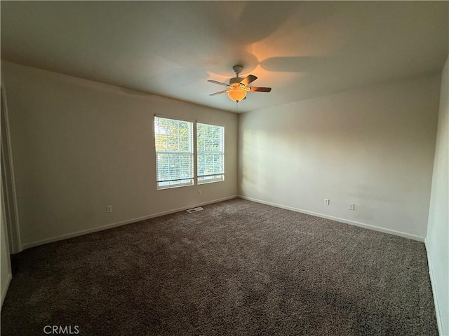 carpeted spare room featuring ceiling fan