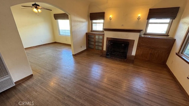 unfurnished living room with ceiling fan, a fireplace, and hardwood / wood-style floors