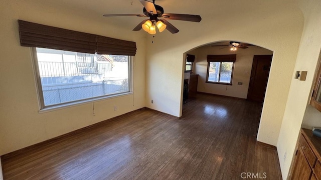 spare room with ceiling fan and dark hardwood / wood-style flooring