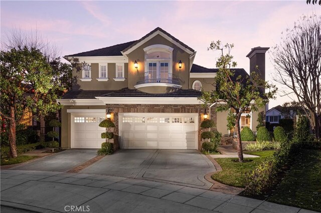 view of front of property featuring a garage and a balcony