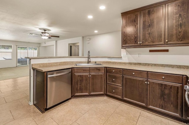 kitchen featuring dark brown cabinetry, dishwasher, a peninsula, and a sink