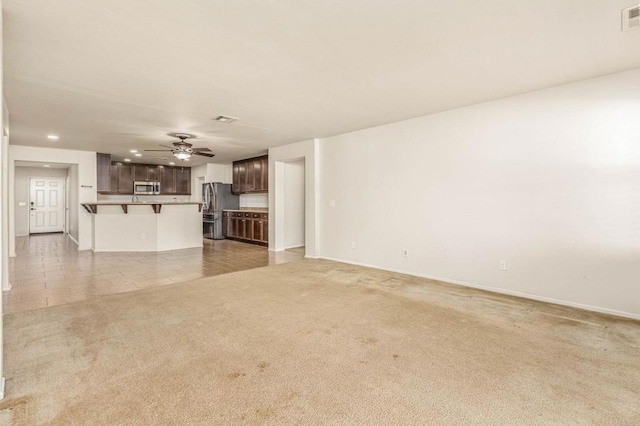 unfurnished living room featuring recessed lighting, visible vents, light carpet, ceiling fan, and baseboards