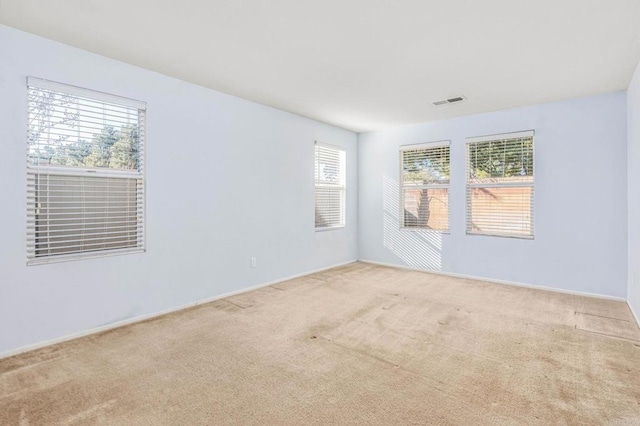 spare room with carpet floors and visible vents