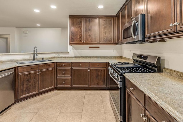 kitchen featuring light tile patterned floors, recessed lighting, light countertops, appliances with stainless steel finishes, and a sink