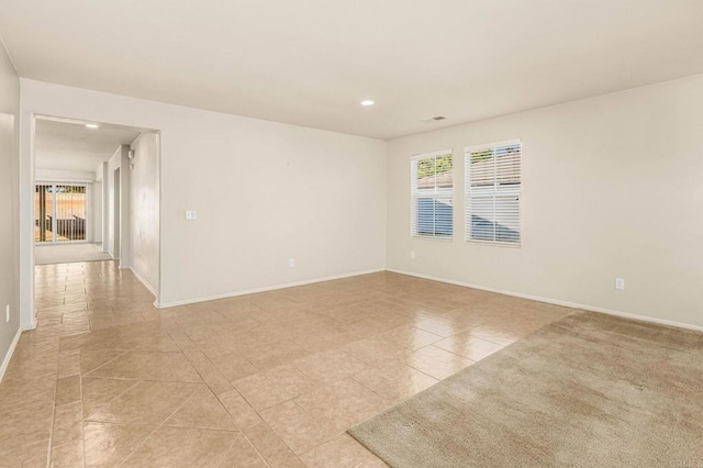 unfurnished room featuring light tile patterned floors, recessed lighting, visible vents, and baseboards