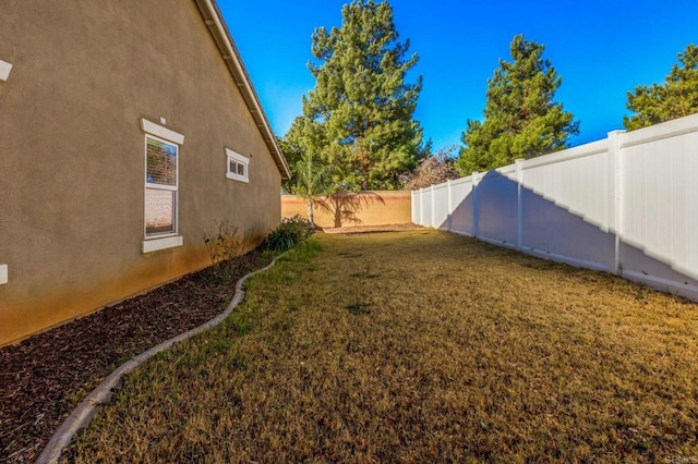 view of yard with a fenced backyard