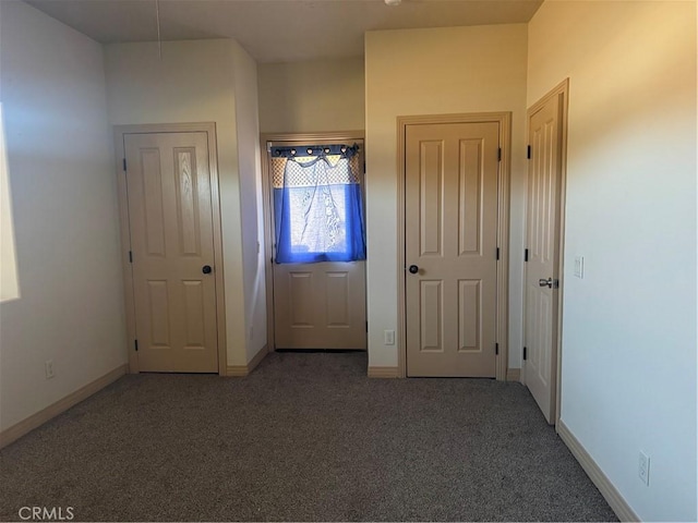 view of carpeted foyer entrance