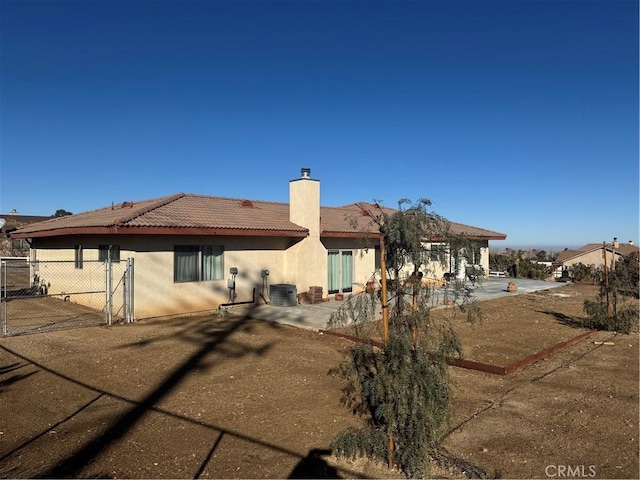 rear view of house with a patio and central air condition unit