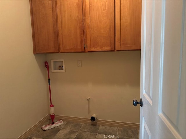 laundry area with cabinets, hookup for a washing machine, and dark tile patterned floors