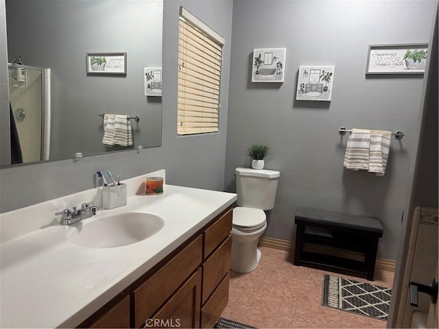 bathroom featuring vanity, walk in shower, tile patterned floors, and toilet