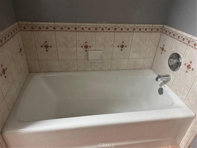 bathroom with a tub to relax in