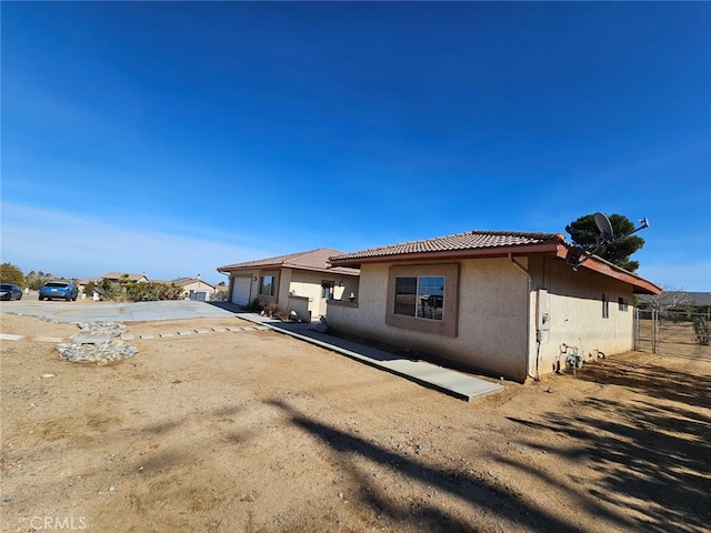 back of property featuring a garage