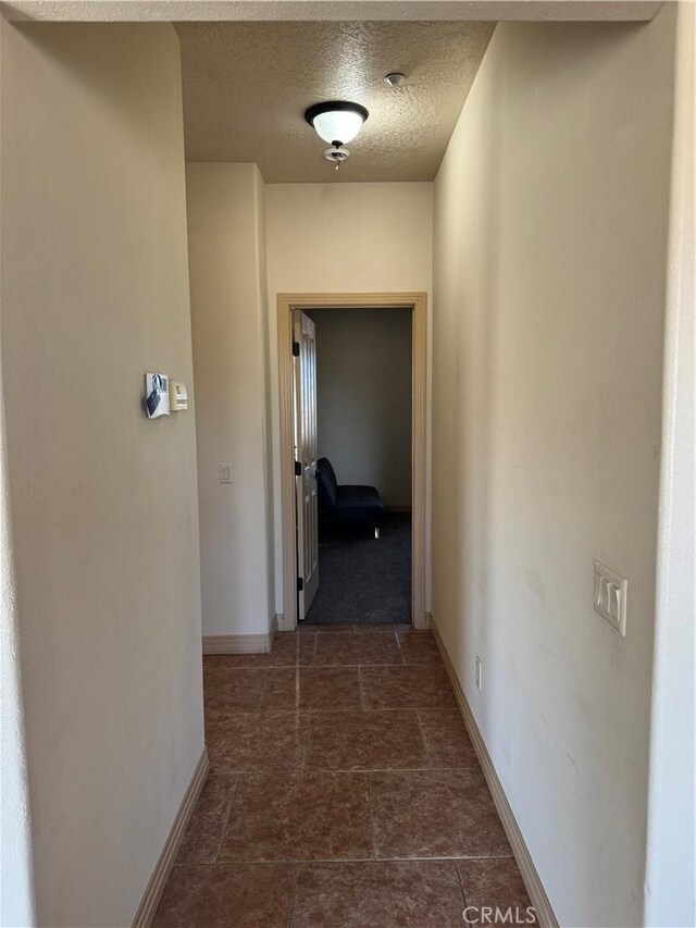 hallway with a textured ceiling