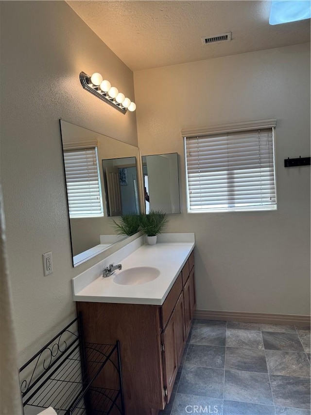 bathroom featuring vanity and a textured ceiling