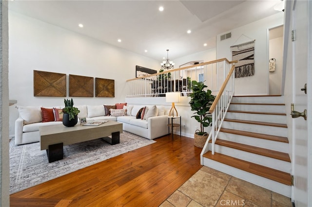 living room with recessed lighting, visible vents, wood finished floors, a chandelier, and stairs