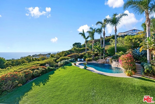 view of pool featuring a water view and a lawn