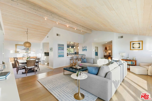 living room with high vaulted ceiling, wooden ceiling, rail lighting, and light wood-type flooring