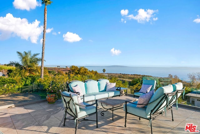 view of patio featuring a water view and an outdoor hangout area