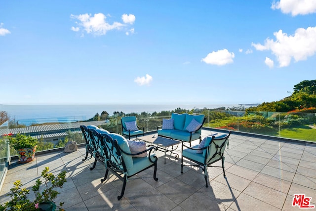 view of patio / terrace with an outdoor living space and a water view