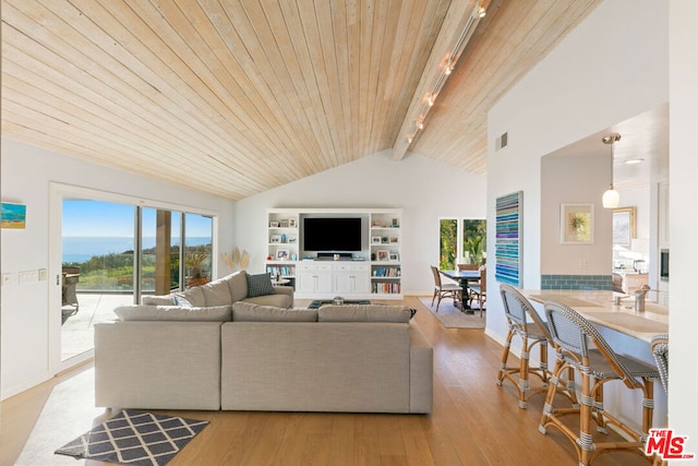 living room with beam ceiling, high vaulted ceiling, track lighting, light hardwood / wood-style floors, and wooden ceiling