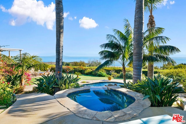 view of swimming pool featuring an in ground hot tub and a water view