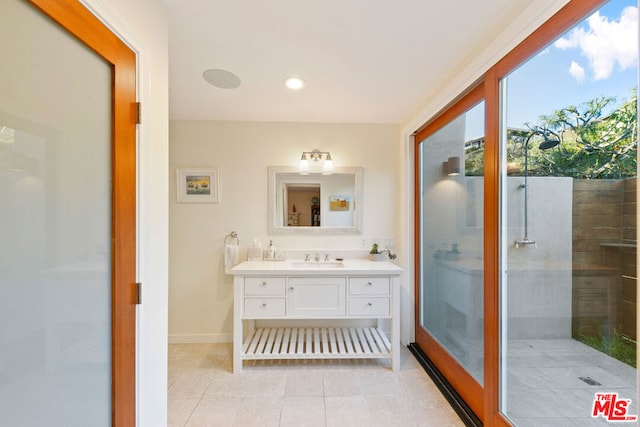 bathroom with tile patterned flooring, a shower, and vanity