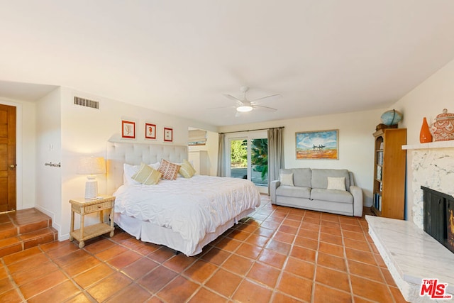 tiled bedroom featuring ceiling fan