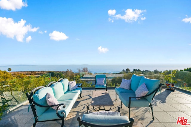 view of patio with an outdoor living space and a water view