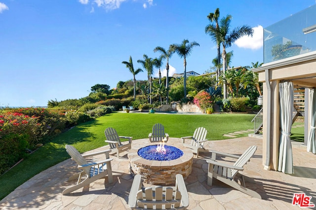 view of patio with an outdoor fire pit