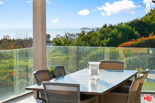 view of patio with a water view