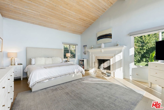 bedroom with high vaulted ceiling, wooden ceiling, and light hardwood / wood-style floors