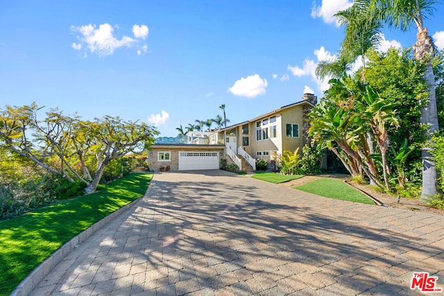 view of front of property with a garage and a front yard