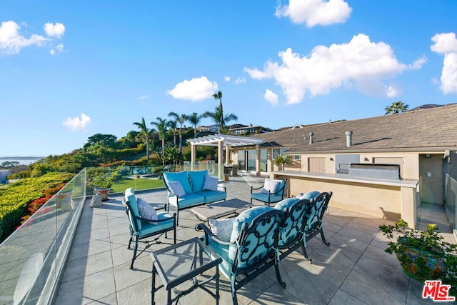 view of patio featuring an outdoor living space, a pergola, and an outdoor kitchen