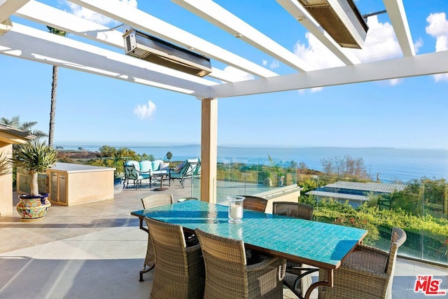 view of patio / terrace with a water view and a pergola